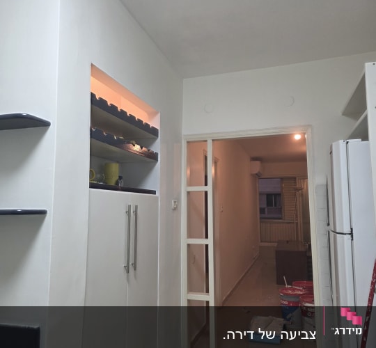 פחיות צבע ומגש צביעה במסדרון בית
